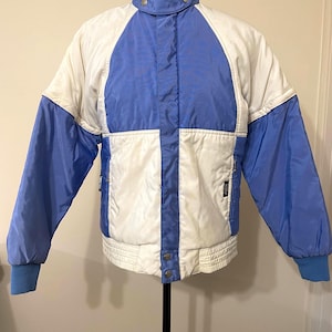 Vintage Killy Made in France Gore-tex ski jacket in white & pale blue. Adjustable sleeves, multiple pockets and hood. Excellent condition.