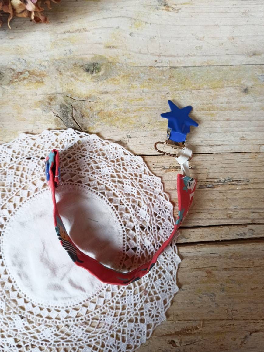 Fabric pacifier chain with metal or light plastic star clip. Chain customizable with name.