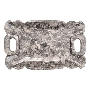 May include: A grey marble serving tray with two handles. The tray has a decorative, scalloped edge.