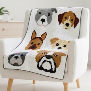 May include: White blanket with a gray border featuring embroidered dog faces in various breeds. The blanket is draped over a white armchair with wooden legs, creating a cozy and decorative accent for a room.