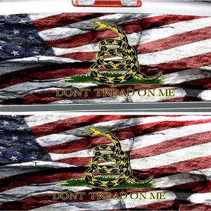 May include: A pair of car window decals featuring a stone-textured American flag with a coiled rattlesnake and the words "Don't Tread On Me".