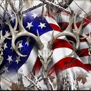 May include: A camouflage pattern with three deer skull silhouettes superimposed on an American flag. The flag is red, white, and blue with stars on the blue field. The camouflage pattern is white, brown, and gray.