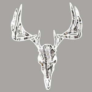 May include: White silhouette of a deer skull with antlers against a gray background. The skull and antlers are filled with a white and brown camouflage pattern.