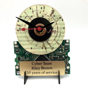 May include: A clock made from a computer hard drive with a gold plaque that reads "Cyber Team Riley Brown 10 years of service".