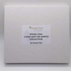 May include: A white box with a label that reads "Spiced Chai Loose Leaf Tea Sample Collection by Chantler Teas".