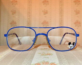 May include: Blue framed glasses with clear lenses and a small Mickey Mouse design on the right lens.