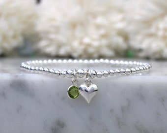 Peridot charm bracelet in sterling silver. August birthstone bracelet. August birthday bracelet. Birthday gift.