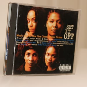 May include: A black CD case with a picture of four women on the front. The title of the CD is "Set It Off" and the text "Music from the New Line Cinema Motion Picture" is printed below the image.