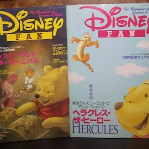 May include: Two vintage Disney Fan magazines. One features Winnie the Pooh and Piglet with Japanese text, the other features Tigger and Winnie the Pooh. Both magazines have the Disney Fan logo.