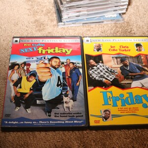 May include: Two DVD cases for the movies Next Friday and Friday, both starring Ice Cube. The cases are yellow with black borders and feature images of the actors and movie titles.