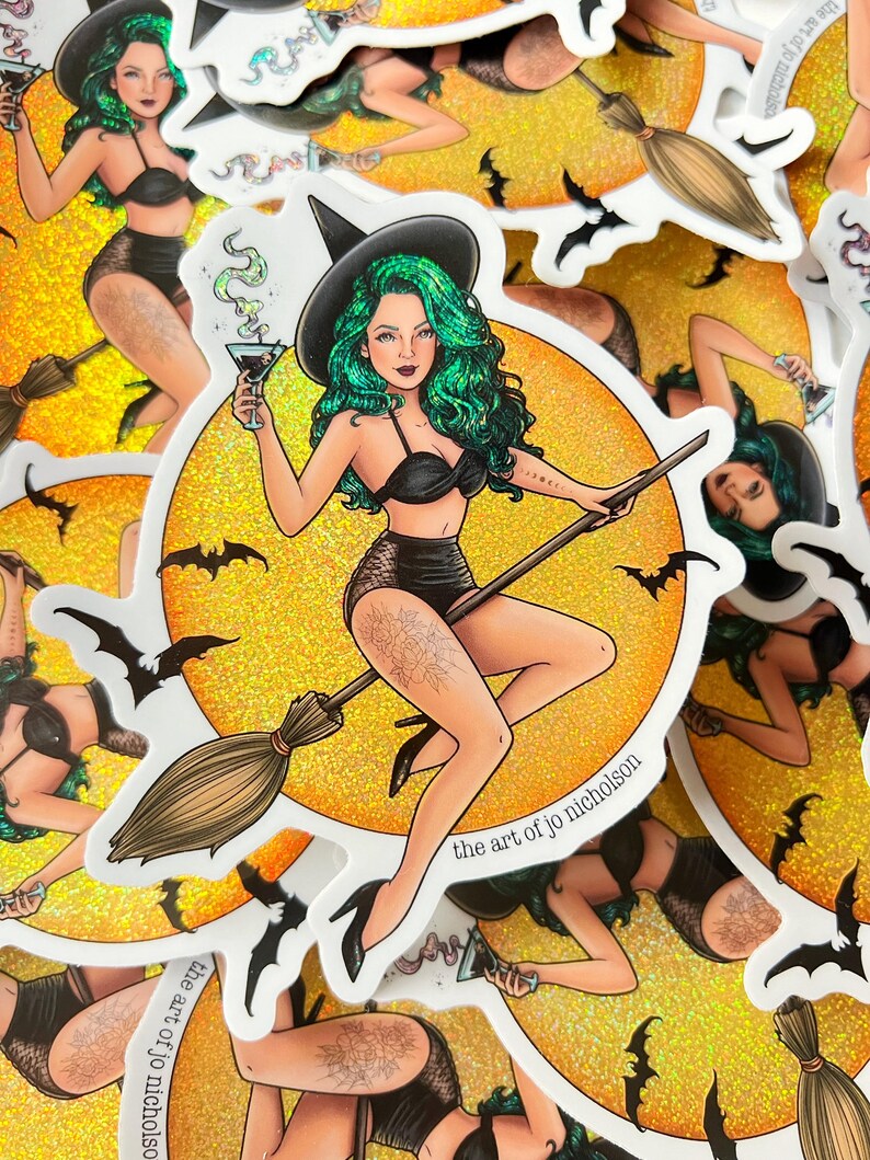 May include: A sticker featuring a witch with green hair and a black bikini riding a broomstick in front of a yellow moon with bats. The text "the art of jo nicholson" is at the bottom of the sticker.