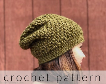 May include: A crochet pattern for a green slouchy beanie hat. The hat is made with a textured stitch and has a slouchy fit. The hat is being worn by a person with long brown hair.