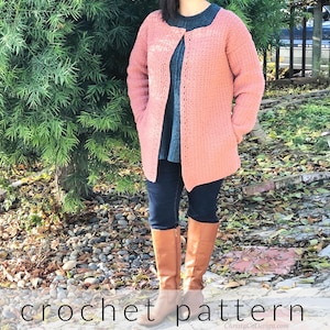 May include: A crocheted sweater in a dusty rose color with a simple, slightly scooped neckline and long sleeves.