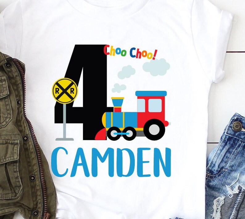 May include: A white t-shirt with a black number four, a red, blue, and yellow train, and the text "Choo Choo!" and "CAMDEN".