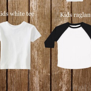 May include: Two blank kids' t-shirts, one white with short sleeves and one white with black raglan sleeves. The text "Kids white tee" is above the white t-shirt and "Kids raglan" is above the raglan t-shirt.