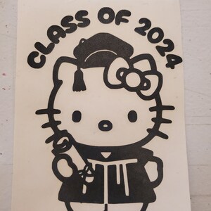 May include: Black and white sticker featuring Hello Kitty dressed in a graduation cap and gown, holding a diploma. The text "CLASS OF 2024" is written in a semi-circle above Hello Kitty.