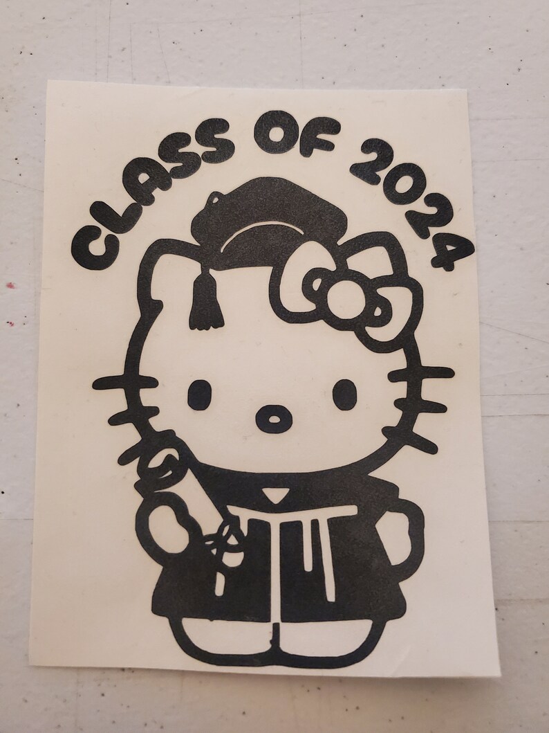 May include: Black and white sticker featuring Hello Kitty dressed in a graduation cap and gown, holding a diploma. The text "CLASS OF 2024" is written in a semi-circle above Hello Kitty.