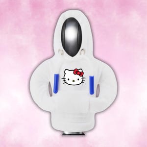 May include: White hoodie with a blue and red Hello Kitty graphic on the front.
