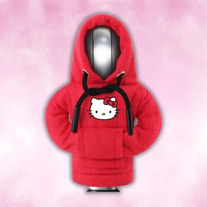 May include: Red hooded sweatshirt with a black drawstring and a white Hello Kitty graphic on the front.