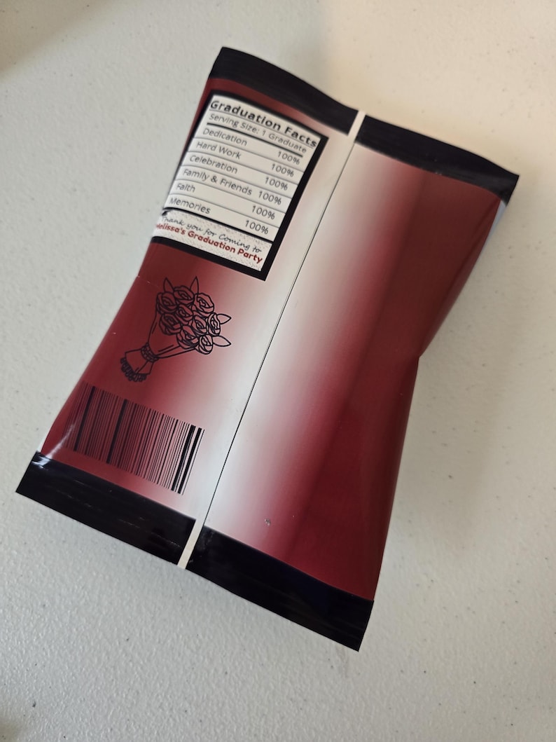 May include: A red and white graduation party favor bag with a black border. The bag has a list of graduation facts with a 100% rating for each item. The text on the bag reads "Graduation Facts" and "Thank you for coming to [Name]'s Graduation Party".