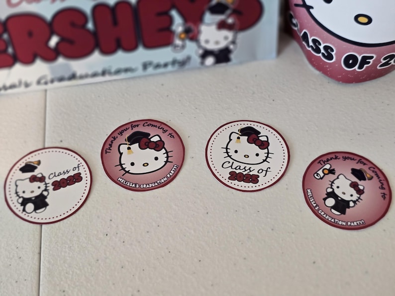 May include: Four round stickers with a Hello Kitty design. The stickers are pink and white with a black outline. The stickers feature Hello Kitty wearing a graduation cap and gown. The text on the stickers reads "Class of 2025" and "Thank you for coming to Melissa's Graduation Party".
