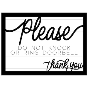 May include: A rectangular black and white sign with the words "Please Do Not Knock or Ring Doorbell Thank You" in a mix of cursive and block lettering. The sign has a black border and a white background with horizontal lines.