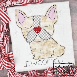 May include: Embroidered design of a beige French bulldog with a grey and white checked nose and a red heart on its nose. The text "I woof you" is below the dog.
