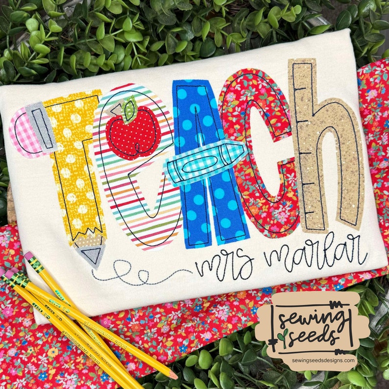 May include: A white fabric tote bag with the word "teach" spelled out in colorful fabric letters. Each letter is decorated with a different school supply, such as a pencil, apple, crayon, and ruler. The name "mrs. marlar" is embroidered below the word "teach".