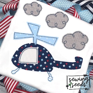 Puede incluir: Un helicóptero azul y blanco con cruces rojas en el lateral, volando sobre tres nubes grises. El helicóptero tiene una pequeña ventana y una hélice en la parte superior. Las nubes están delineadas en negro y tienen un patrón texturizado. La imagen está sobre un fondo blanco con el texto "sewing seeds" en la esquina inferior derecha.