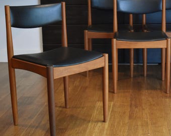 Four restored teak and black curved-back dining chairs by Frem Rojle, circa 1960s