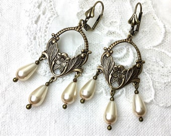 Cream pearl floral chandelier antiqued brass dangle earrings