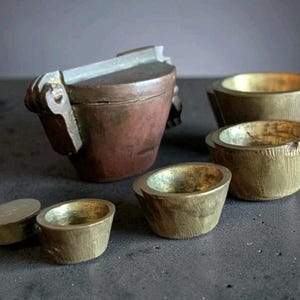 May include: A set of three ceramic mugs with a speckled, matte finish in cream, light grey, and dark grey. Each mug has a simple, minimalist design, ideal for coffee or tea.