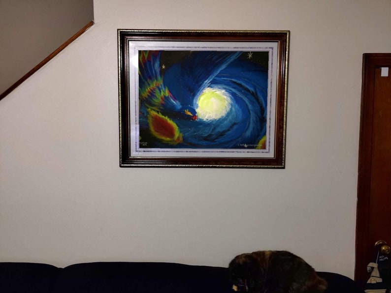 May include: A framed painting of a colorful abstract design with a blue and white swirl, a yellow sun, and a red and yellow flame. The painting is in a dark wood frame with a gold trim.