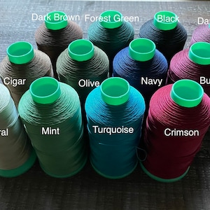 May include: Spools of waxed thread in various colours, including dark brown, forest green, black, dark burgundy, cigar, olive, navy, burgundy, natural, mint, turquoise, and crimson.