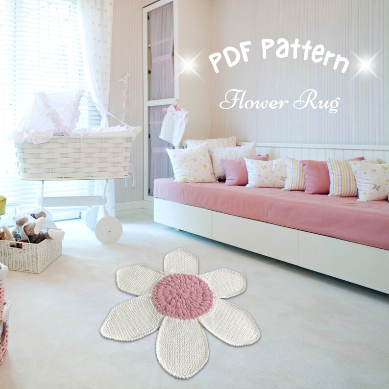 May include: A white crocheted flower rug with a pink center. The rug is in a nursery with a white crib and a pink couch.