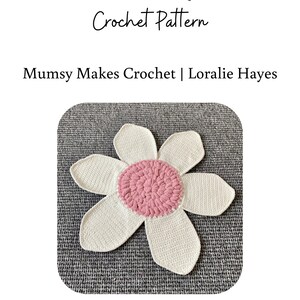 May include: A white crochet flower rug with a pink center. The rug is on a gray surface. "Flower Rug Crochet Pattern" and "Mumsy Makes Crochet | Loralie Hayes" are written above the rug. "2024 Mumsy Makes, Loralie Hayes www.mumsymakescrochet.com All Rights Reserved. Please feel free to sell items you make using this pattern. When possible please link back to my pattern. You may not distribute, alter, copy or sell this pattern nor claim it as your own." is written below the rug.
