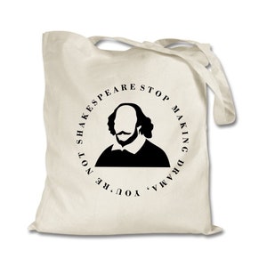 May include: A white canvas tote bag with a black circle design featuring a silhouette of William Shakespeare and the text "You're not Shakespeare stop making drama".