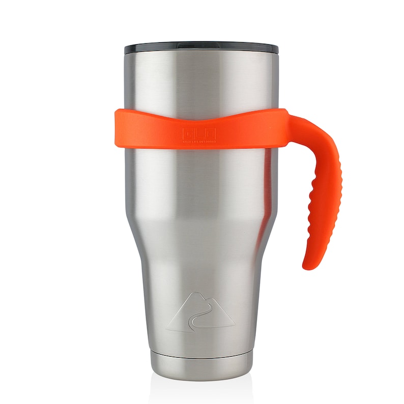 May include: A stainless steel travel mug with a black lid and an orange silicone handle and grip. The mug has a mountain logo on the side.
