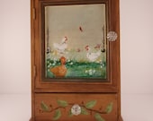 Mimi cabinet with hens and chicks a redbird setting on the fence