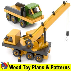 May include: Two wooden toy trucks, a green dumper truck and a yellow crane truck. Both trucks have black wheels and are made of wood. The crane truck has a yellow boom and a black hook.