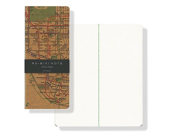 May include: A small, brown notebook with a vintage-style map of a city's subway system on the cover. The cover also has the text "RO-BIKI NOTE" and "Metro Map" printed on it. The notebook is closed and sitting on a white surface.