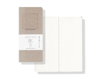 May include: A brown notebook with a grid pattern on the cover. The cover has the text "RO-WIKI NOTE" and "yama-hami stationery". The notebook is open to reveal white pages with a subtle grid pattern.