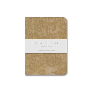 May include: A tan notebook from the Texture Series, with a textured cover. The notebook has a white band across the middle with the text "RO-BIKI NOTE" and "Texture Series". Below the text is "Blank and Free writing 60pages".