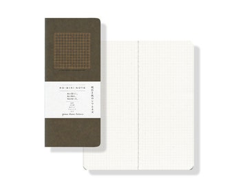 May include: A brown notebook with a grid pattern on the cover. The cover also features the text "RO-BIKI NOTE" and Japanese text. The notebook is open to reveal a blank page with a grid pattern.