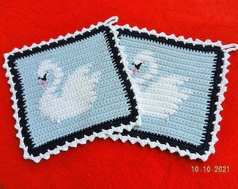 2 crocheted potholder swans