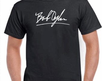 May include: A black t-shirt with a white signature that reads "Bob Dylan" on the front.
