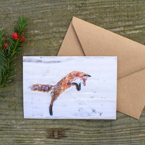 Carte de Noël renard roux bondissant, carte artistique A6 noire.
