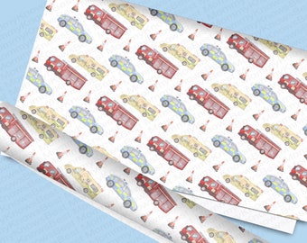 May include: A white wrapping paper with a repeating pattern of red fire trucks, yellow ambulances, blue police cars, and orange traffic cones. The pattern is on a white background.