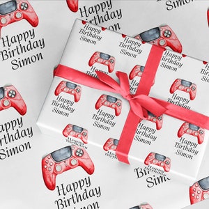 May include: Red and white wrapping paper with a repeated pattern of a red video game controller and the text "Happy Birthday Simon".