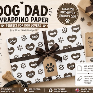 May include: Wrapping paper with a white background and a pattern of brown paw prints and hearts that say "DOG DAD". The gift is tied with a brown ribbon and a tag with a paw print. Text reads "Great for Birthdays & Father's Day!"